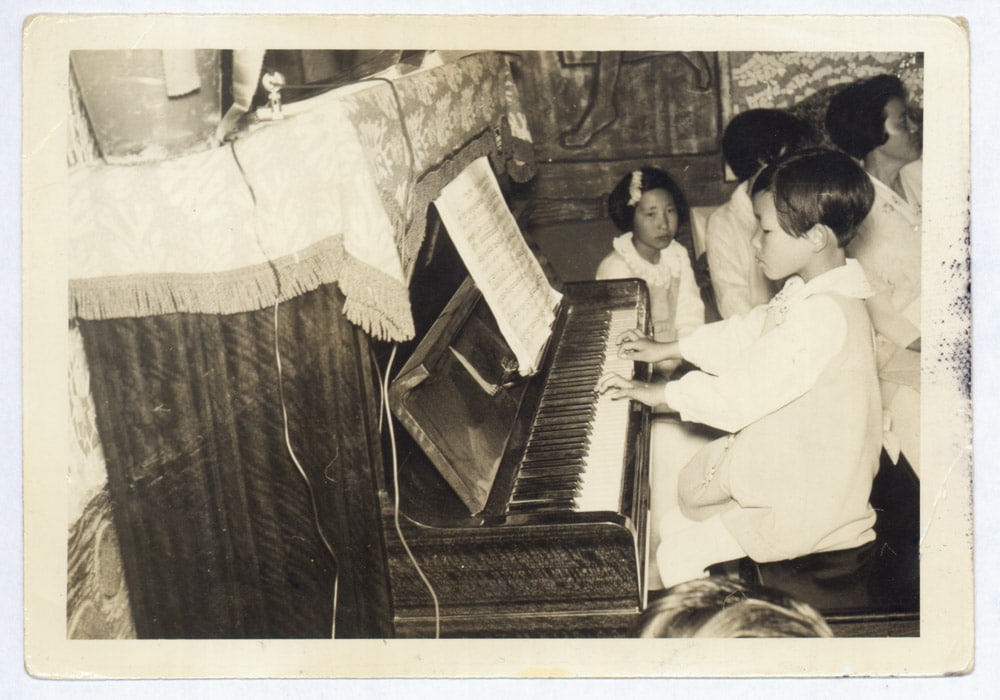 A photo of Unsuk Chin as a child, at the piano 
